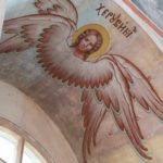 Artistic fresco of an angel painted on a church ceiling, depicting religious iconography.